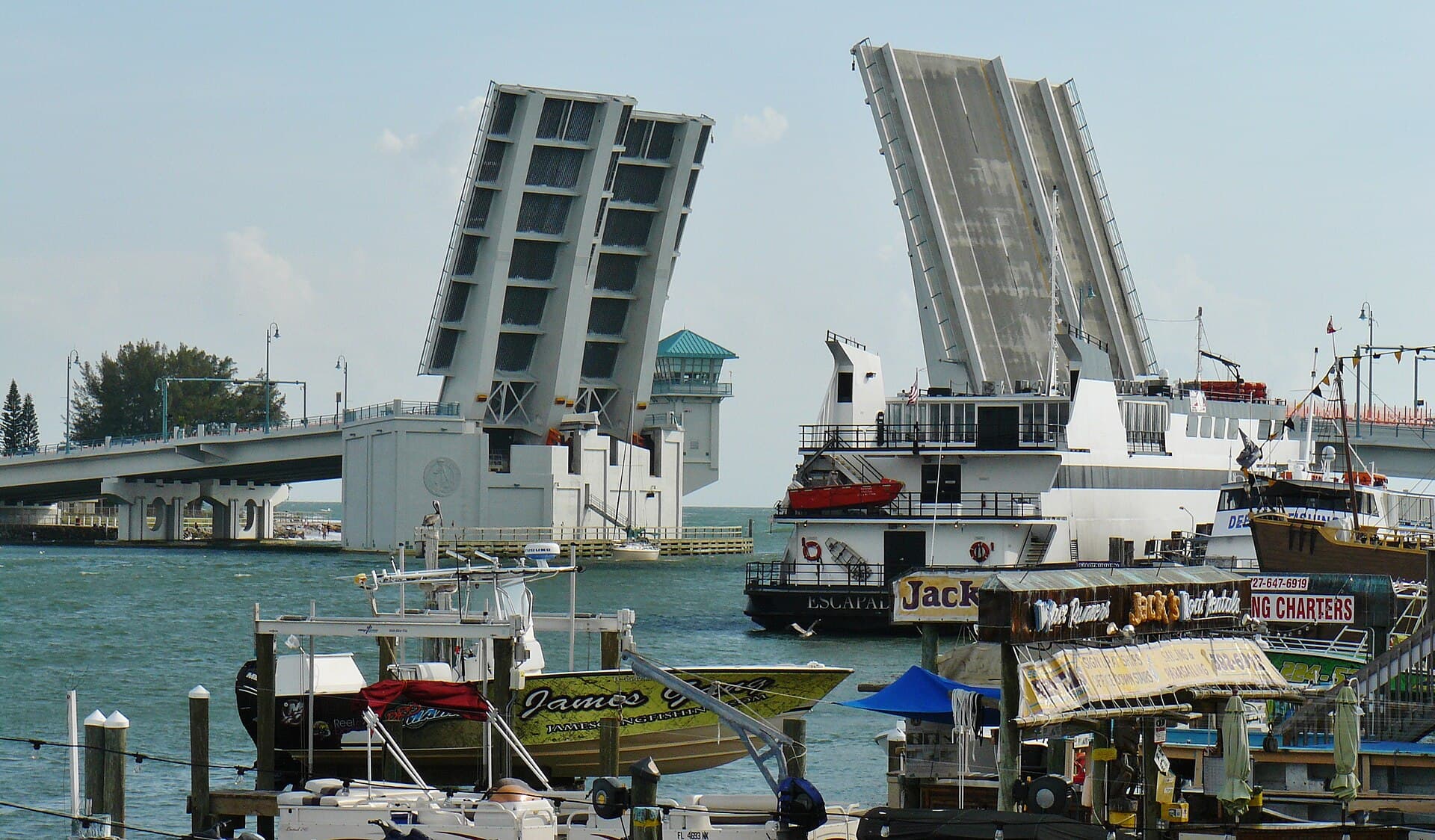 John's Pass drawbridge, tour boats, and waterfront village near Madeira Beach